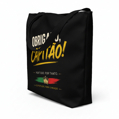 A black canvas tote bag with yellow and white Portuguese text reading 'Obrigado, Capitão!' and a small red, green, and yellow graphic near the bottom, shown on a plain white background.